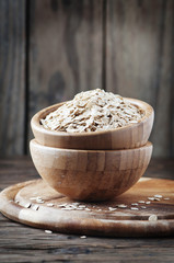 Uncooked oatmeal on the wooden table