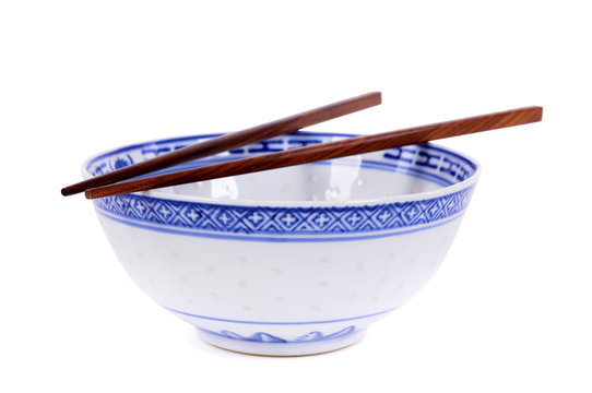 Classic blue pattern empty Chinese rice bowl with wooden chopsticks isolated on white background photo