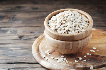 Raw oatmeal cereal on the wooden table