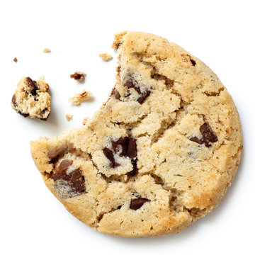 Light chocolate chip cookie, bite missing with crumbs from above