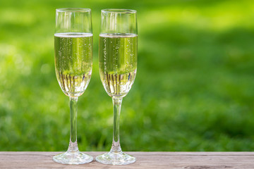 Two champagne glasses and wedding rings outdoor