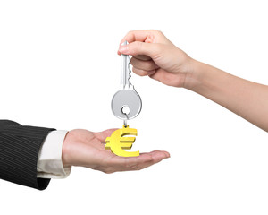 Woman hand giving key euro sign keyring to man hand