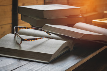 book, pencil and glasses