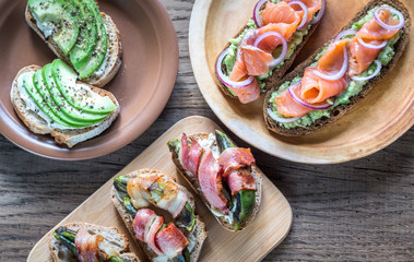 Toasts with avocado and different toppings