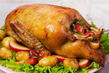 Roast duck with potato, apples, salad, thyme and rosemary.