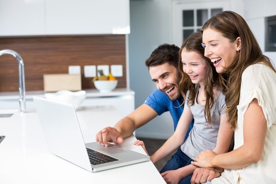 Happy Family Looking At Laptop