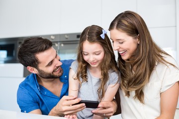 Man showing smart phone to family 