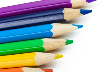 Many different colored pencils on white background