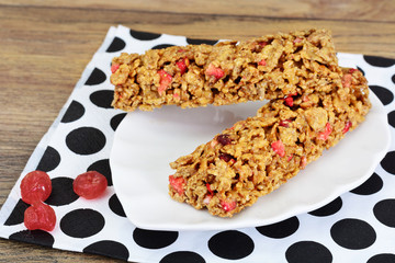 Muesli bars with sunflower seeds, nuts and dried cherrieson Wood