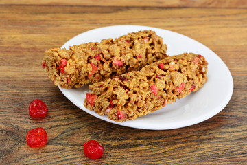 Muesli bars with sunflower seeds, nuts and dried cherrieson Wood
