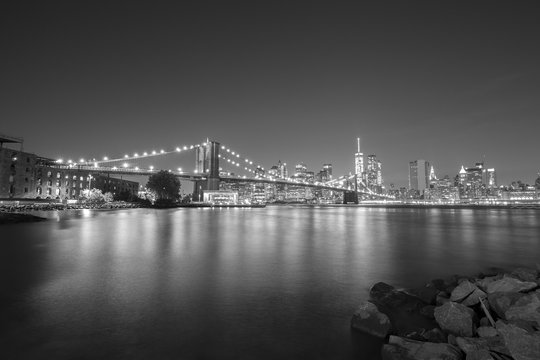 Black and white picture of New York City skyline with Brooklyn Bridge, USA.