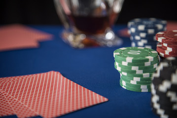 Poker cards and gambling chips on casino table