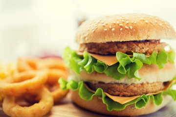 close up of hamburger or cheeseburger on table