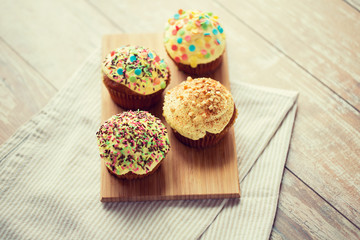 close up of glazed cupcakes or muffins on table