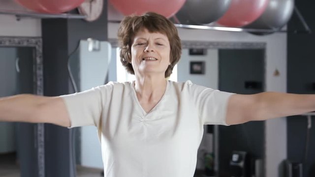Senior woman doing exercises at gym, mature, fitness, stretching, yoga