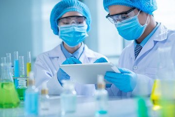 Fototapeta premium Chemists with tablet computer
