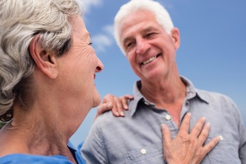 Senior couple embracing each other on the beach
