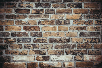 Weathered texture of stained old dark brown and red brick wall background