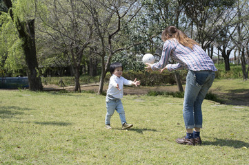 Mother and son playing with a ball in the park