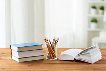 close up of crayons or color pencils and books