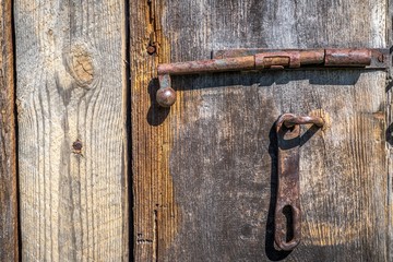 old wooden door with an iron bolt