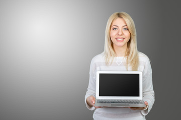 Smiling mature woman holding laptop