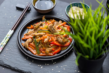 Chinese Cuisine - Pork with Vegetables Deep Fried in Sour-Sweet Sauce on Dark Background