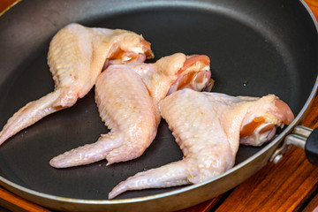 raw chicken wings in pan
