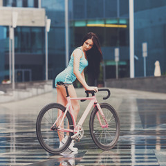 Fototapeta na wymiar Young slim sexy sportive woman on bicycle