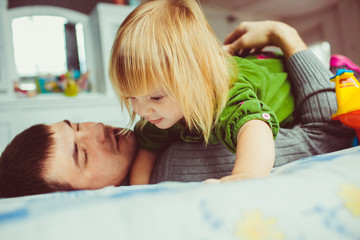 Daughter is playing with her father