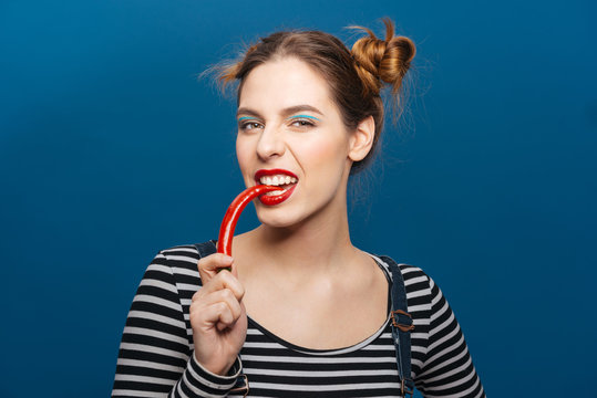 Portrait of attractive pretty young woman with chilli pepper