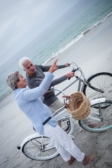 Senior couple having ride with their bike
