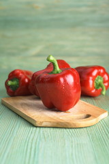 Red pepper on the wooden table.
