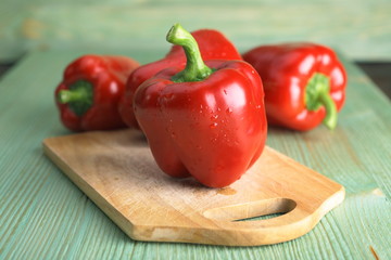 Red pepper on the wooden table.