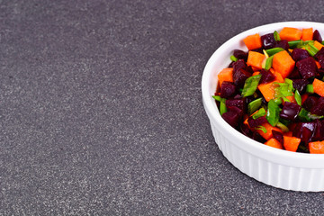 Fototapeta na wymiar Salad of Cooked Beets and Carrots with Green Leek