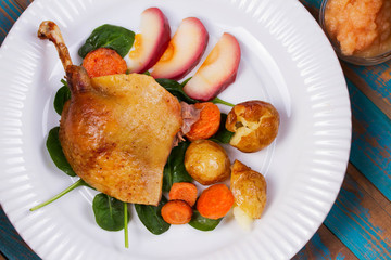 Duck on spinach, potato, apple sauсe and carrot. Overhead View