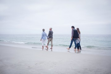 Family walking together on the beach