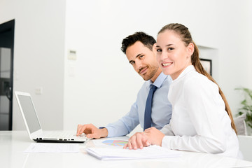 business people man and woman working together with a laptop computer in office