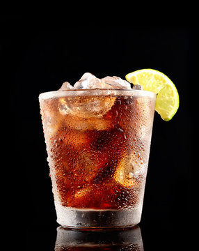 Cold Cola With Ice In A Glass On A Black Background
