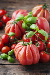 Red sweet tomato and basil on the wooden table