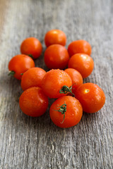Fototapeta na wymiar Cherry tomatoes on wooden desk