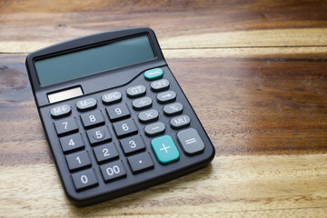 Calculator with wooden table background