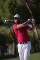 golfer hitting a sand bunker shot