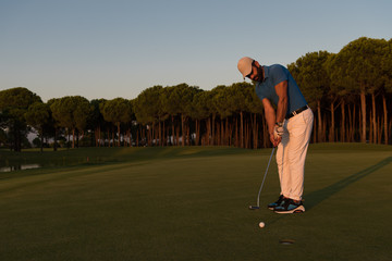 golfer  hitting shot at golf course
