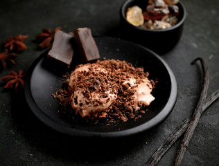 balls ice cream, vanilla sticks  , anise and chocolate on a dark background