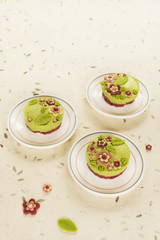 Raw vegan spinach cakes with the raw marzipan flowers and leaves