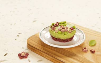 Raw vegan spinach cake with the raw marzipan flowers and leaves