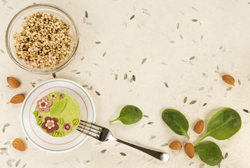 Raw vegan spinach cake with the raw marzipan flowers and leaves