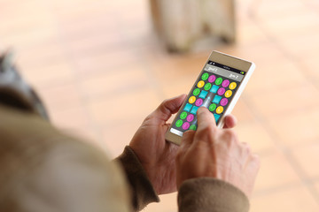 Brown young man smartphone videogame