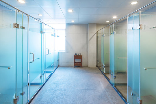 glass showers in modern washing room in gym